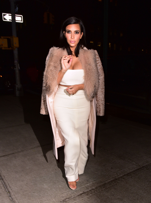 In a Givenchy coat, Calvin Klein top and skirt, and Manolo Blahnik heels while out in New York.
