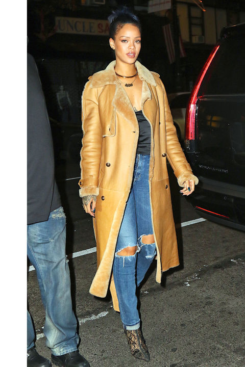 Wearing a shearling coat with a slinky black tank, distressed jeans and lace booties for an evening out in New York City.