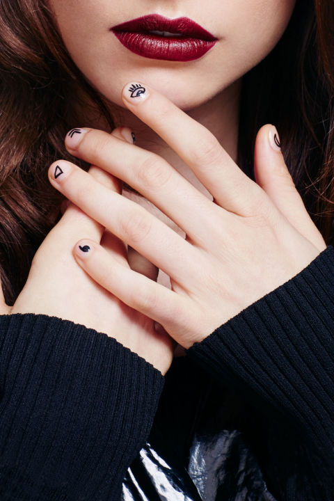 A badass berry lip needs a manicure to match. Nail art aficionado Mei Kawajiri freehanded designs inspired by "finger tattoos" using black acrylic paint and a skinny brush. For a temporary (and needle-free!) alternative to getting ink done, try Maybelline New York Color Show Back to Black Nail Lacquer in Patent Black.