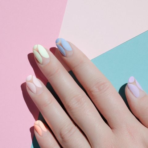 On the opposite side of the color spectrum is the matte pastel, seen here in a negative nail design.Design by @palemoonseattle