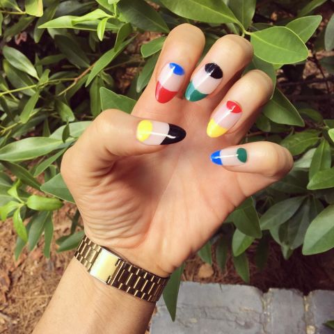 This negative nail design uses the official Olympics colors to paint the half moons and tips.Design by @ladie_evil